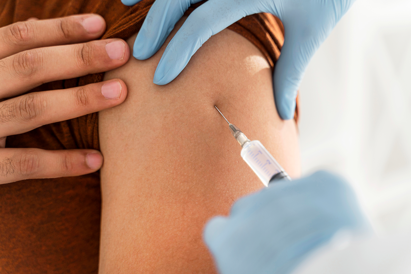 close-up-man-being-vaccinating-by-doctor